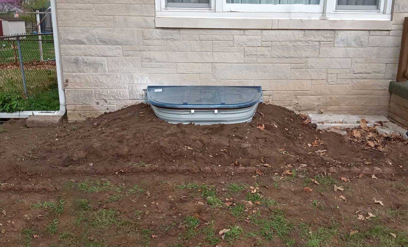 egress window installed with proper dirt encasement
