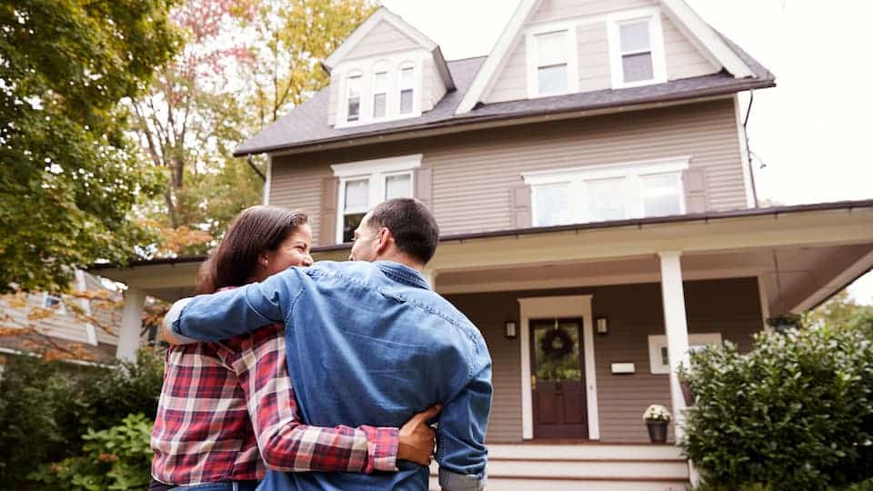 Homeowners looking at their home